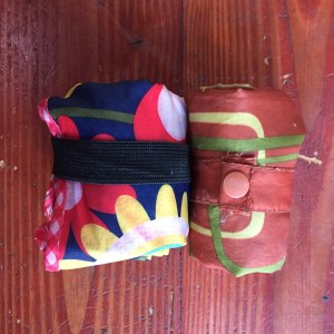 Envirosax Slingasx rolled up next to original Envirosax reusable portable shopping bag