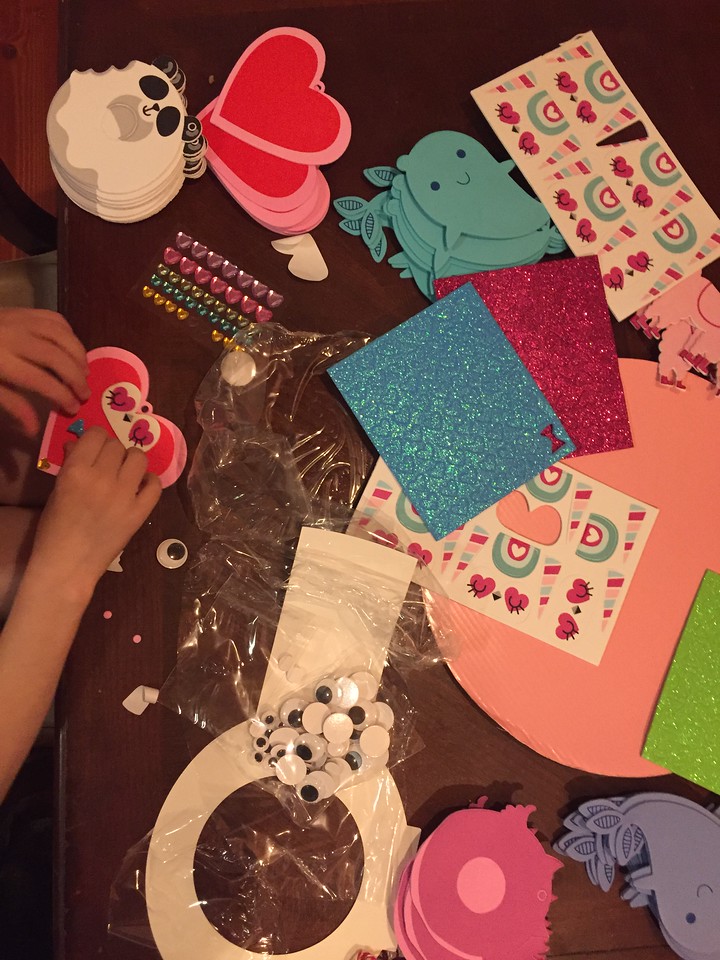 child making Valentine's Day crafts on