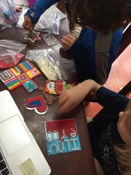 Kids at table working on fuse Perle melty bead projects