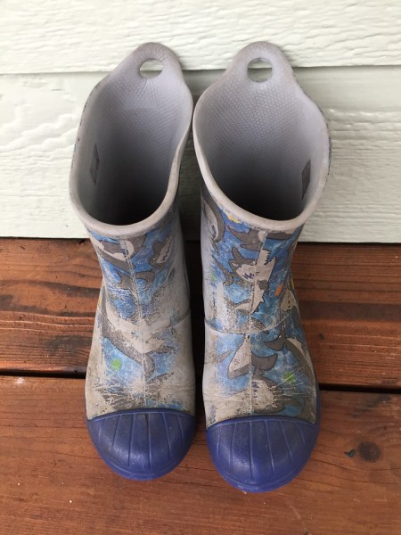 Crocs Bump It Rain boots in blue shark pattern worn off in places