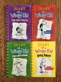 Diary of a Wimpy Kid by Jeff Kinley original book in series with red cover, The Ugly Truth purple cover, The Last Straw green cover, Dog Days yellow cover