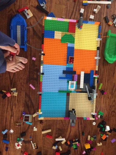 Nine year old assembling Lego pirate ship without using instruction manual or purchased set