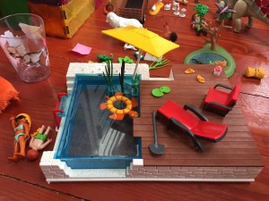 Playmobil City Life Pool with Terrace set up with turtle float yellow umbrella and red lounger and chair poolside deck