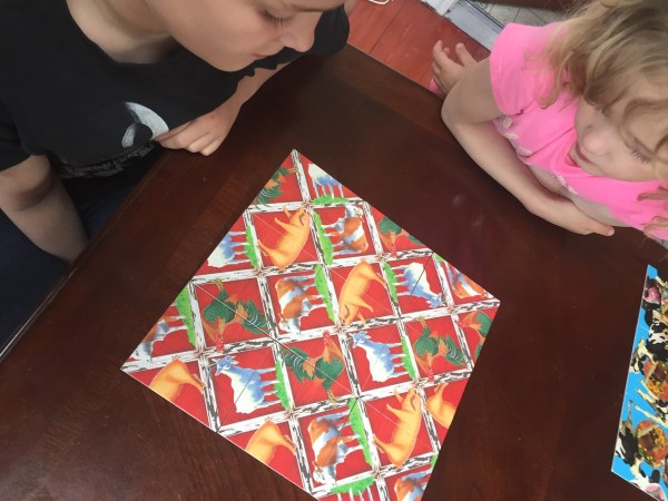 Completed farm barn animals theme scramble squares puzzle completed by kids at table