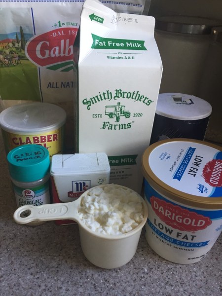 Skim milk, cornstarch, low fat cottage cheese, pepper, salt, garlic powder, Parmesan cheese on counter
