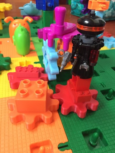 Lego droid brick creation on top of Gears! Gears! Gears! construction attached with bricks on gears