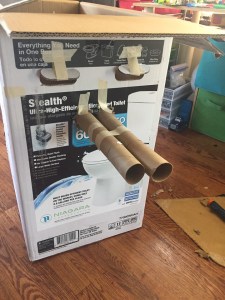 Tank made by kids art project from cardboard box and toilet paper tubes connected together