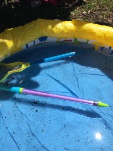 Saber blaster water gun shooter tube floating in inflatable wading pool