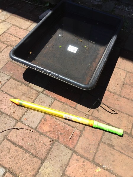 Super water saber next to container of water