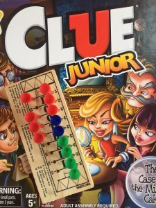 Clue Junior board game for kids in box with football peg game on top