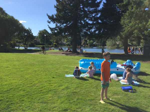 H20Go Bahama Wave Island Float raft boat on grass at park with river in background
