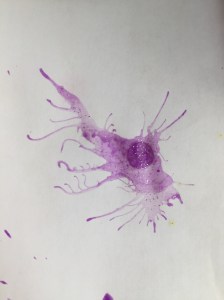 Child's paint project made by blowing air through straw to move paint on paper