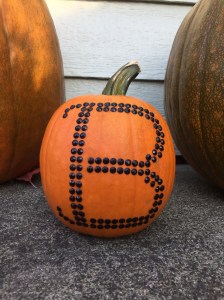 Small pumpkin decorated with adhesive rhinestone stickers in shape of letter B