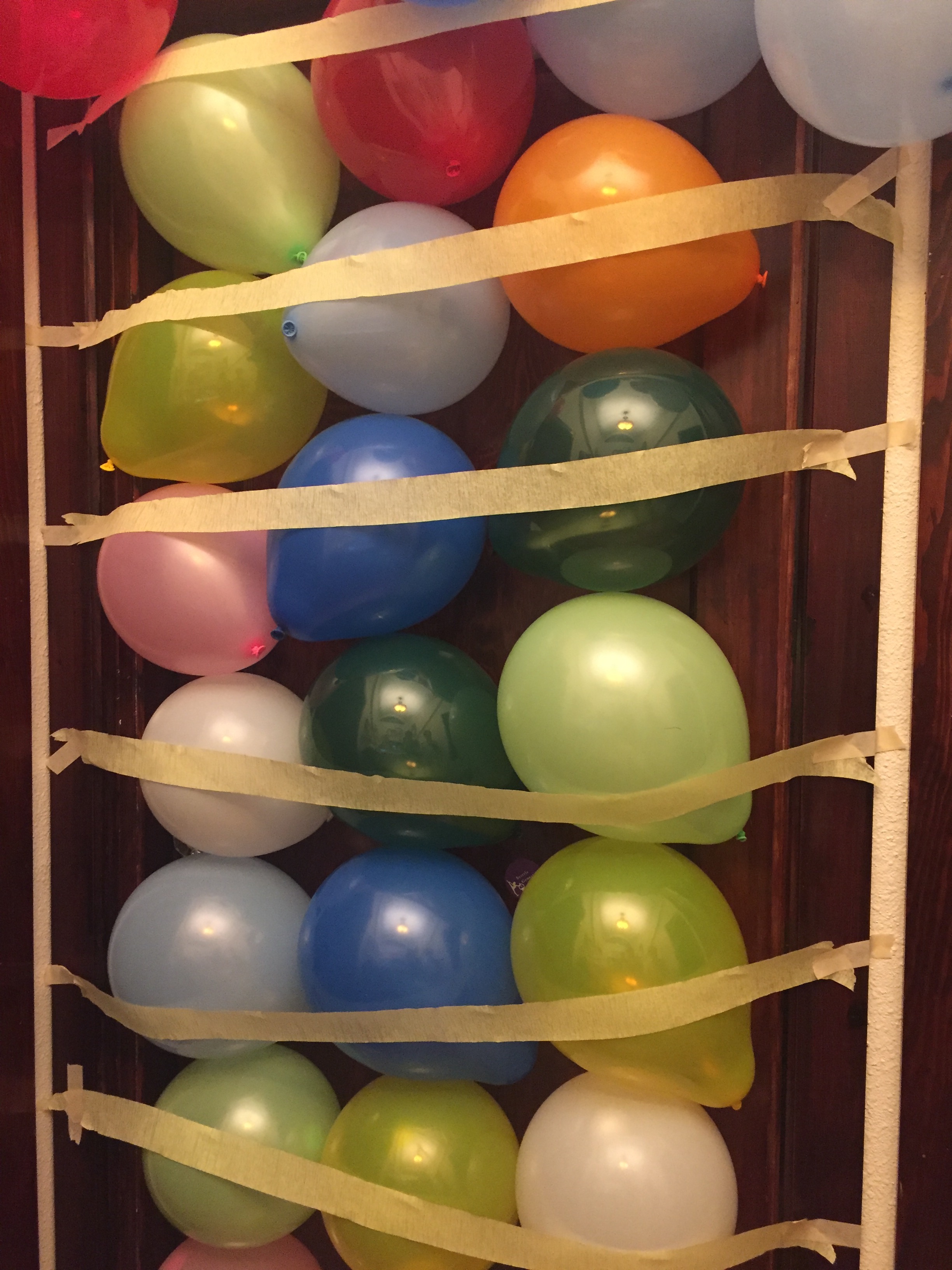 Balloons attached to kid's bedroom door for birthday surprise