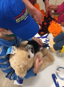 Child dressing birthday bear at Build A Bear store