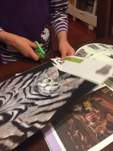Eight year old child cutting out paper for Mrs. Norris Filch's cat Harry Potter origami
