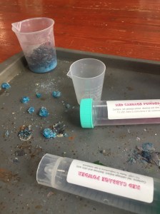 Cabbage Chemistry set for kids tubes on cookie sheet with remains of science experiment