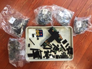 Cobi building blocks offbrand Lego World War II airplane under construction with pieces on cookie sheet