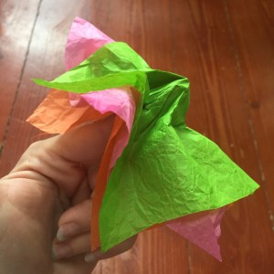 Tissue paper flower making twisting paper around finger