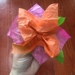 Tissue paper flower made from green, pink, and orange squares