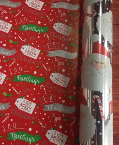 Reversible jumbo roll wrapping paper Santa heads on silver background and Very Merry gift tags on red background