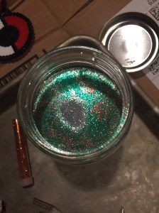Glitter in water in jar as seen from above