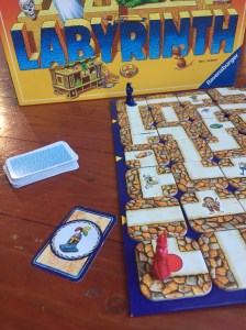 Labyrinth game with treasure card showing knight's helmet and red wizard in starting position