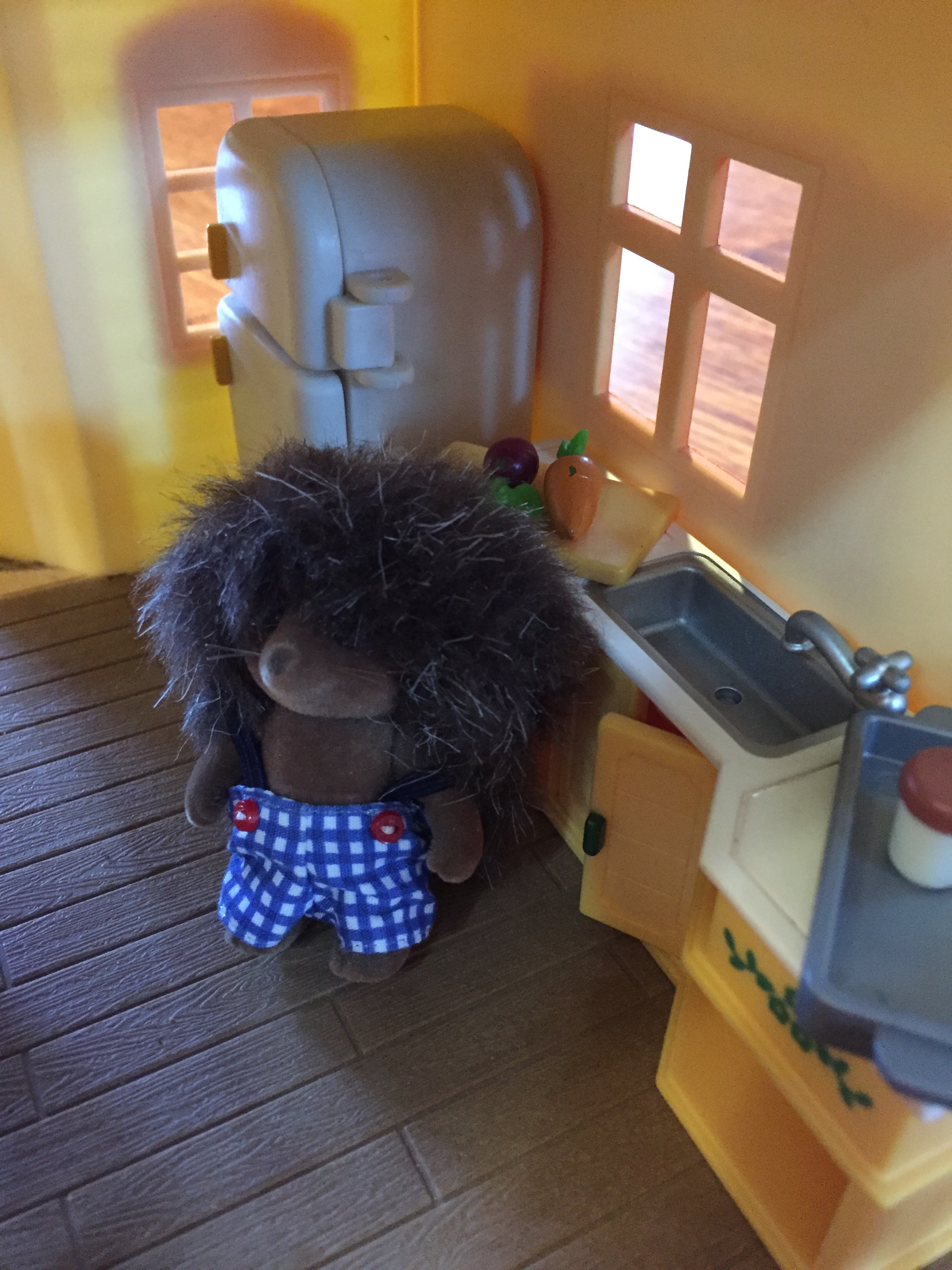 Calico Critters Hedgehog in kitchen of cozy cottage