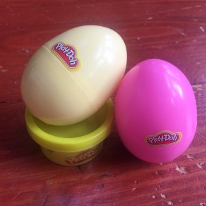 Yellow and pink Play-Doh in plastic Easter eggs and tiny container