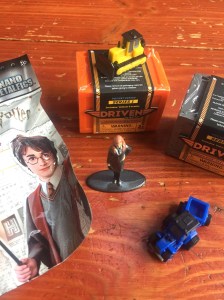 Harry Potter figure blind bag and Hermione Grainger figure Driven Pocket Series garages bulldozer and blue tractor with trailer attached