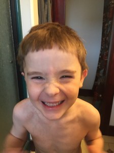Child laughing after haircut shor