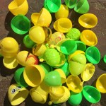 Green and yellow plastic Easter eggs emptied on ground in pile