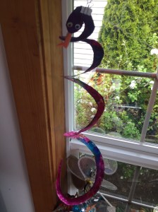 Snake paper plate kid craft project hanging in window