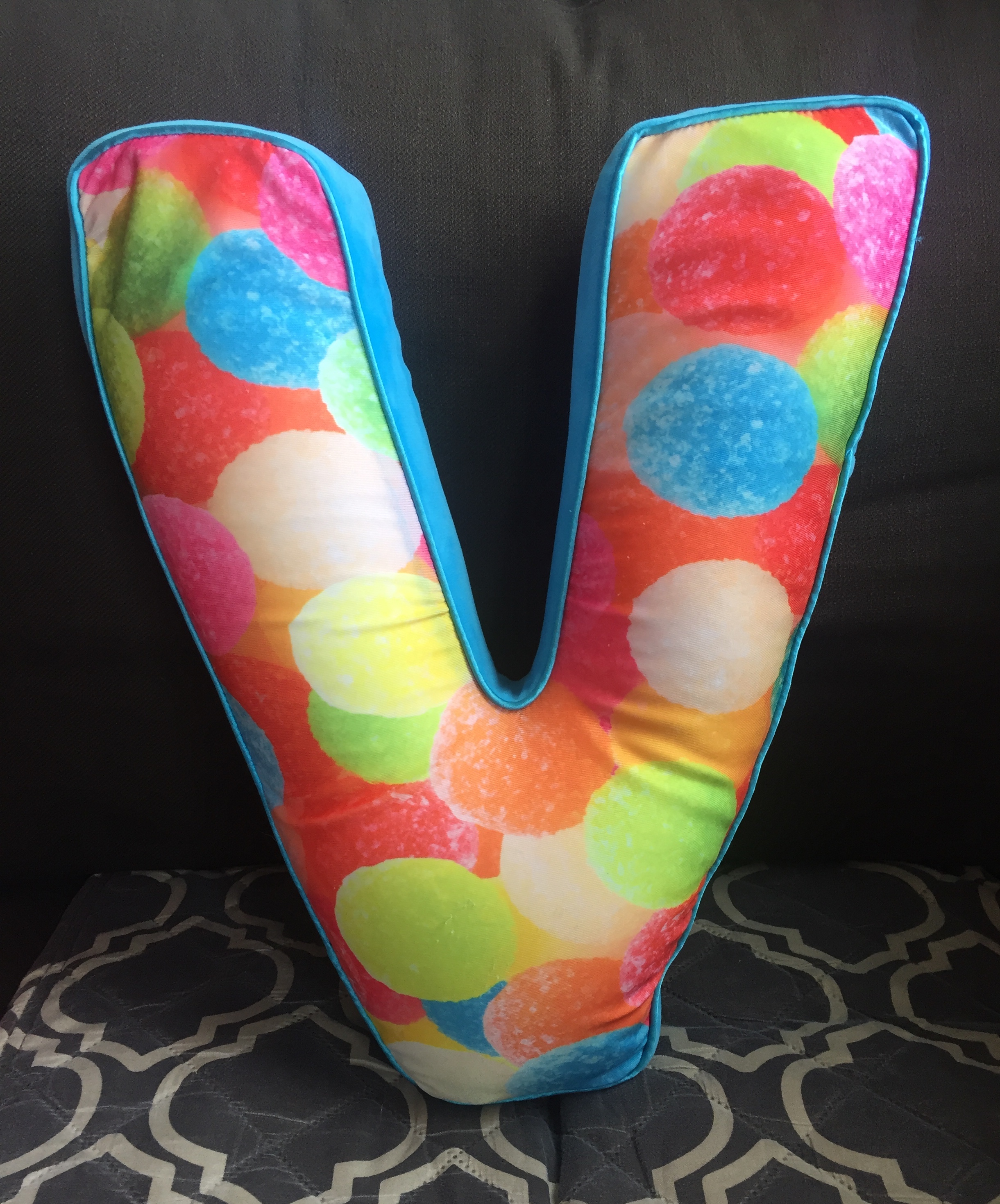 iscream Lettermania V shaped pillow with gumdrop image on front with bright blue backing