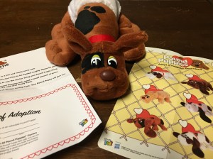 Pound Puppy Newborn stuffed animal brown with black spots with adoption certificate and sheet showing different patterns, colors, and styles