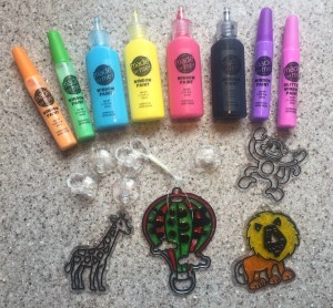 Made By Me Create Your Own Window Art suncatcher kit for kids including paint, string, suction cup hooks, and plastic designs