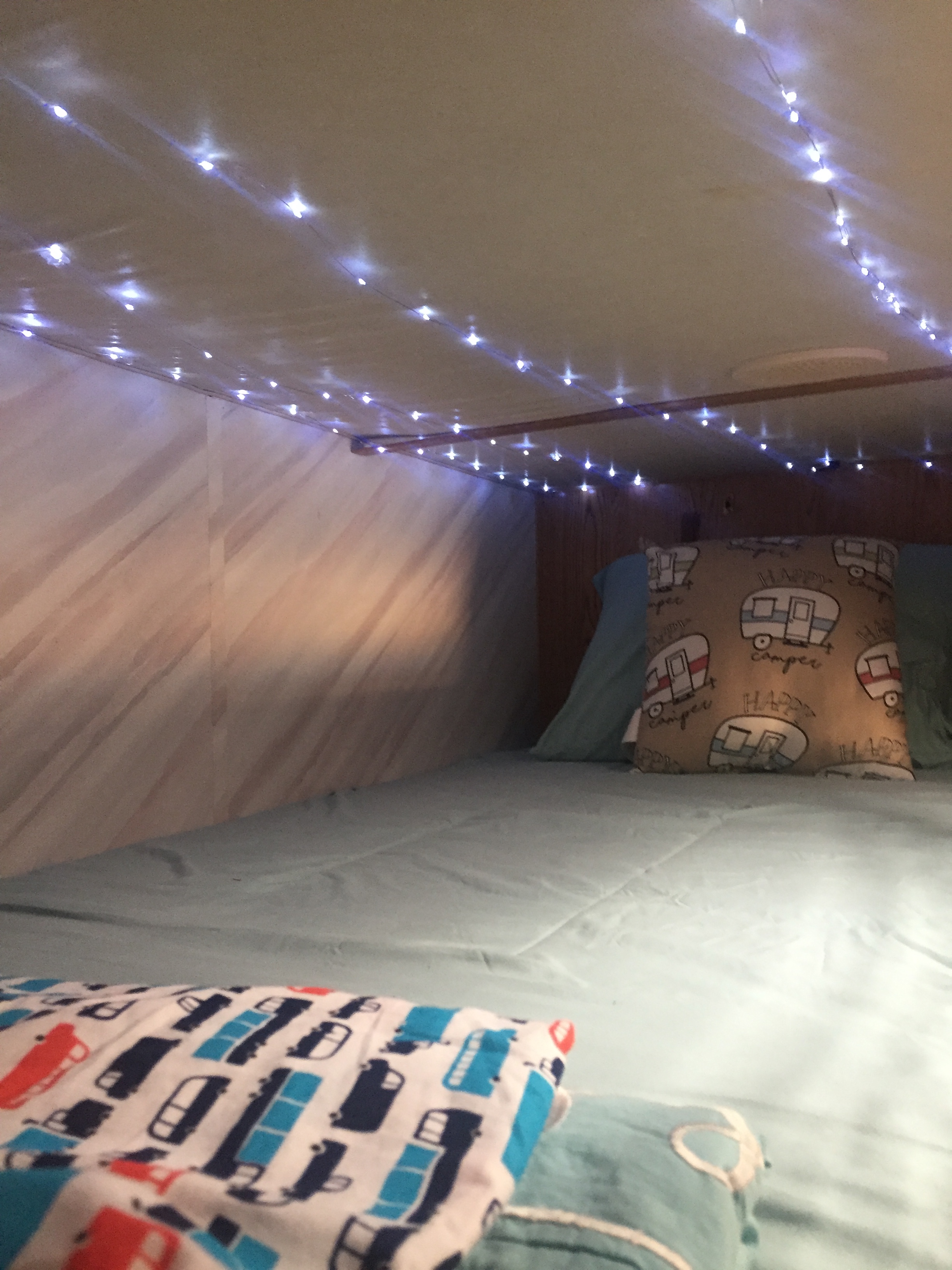 Fairy lights for kids installed on ceiling of top bunk of RV travel trailer
