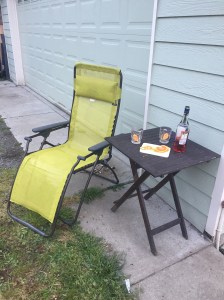 Lafuma reclining lounge chair in lime green next to small table with drink mixings on it