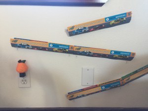 Paper Trax toy car tracks mounted on wall under window