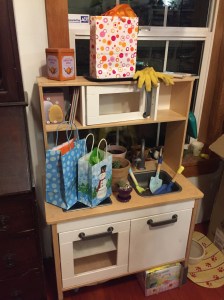 IKEA play kitchen after transforming it into garden center potting bench for older kids