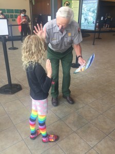 Nine year old girl getting sworn in as Junior Ranger by ranger at