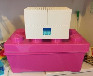 IKEA LEGO Bygglek storage boxes set of three sitting on top of plastic LEGO storage box with oversized studs