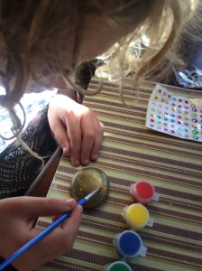 Child painting rock from Joyeza rock painting kit