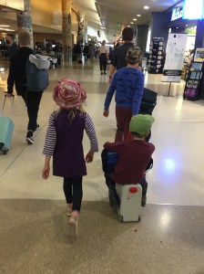 Kids walking through airport as seen from behind