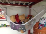 Stuffed animal hammock holding animals hung underneath top bunk bed