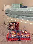 Battleship Shots game Clue Junior kids board game in front of IKEA Hemnes Daybed in twin configuration