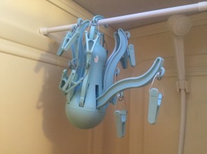 PRESSA hanging octopus from IKEA hanging from curtain rod in RV shower with on turquoise tentacle folded down