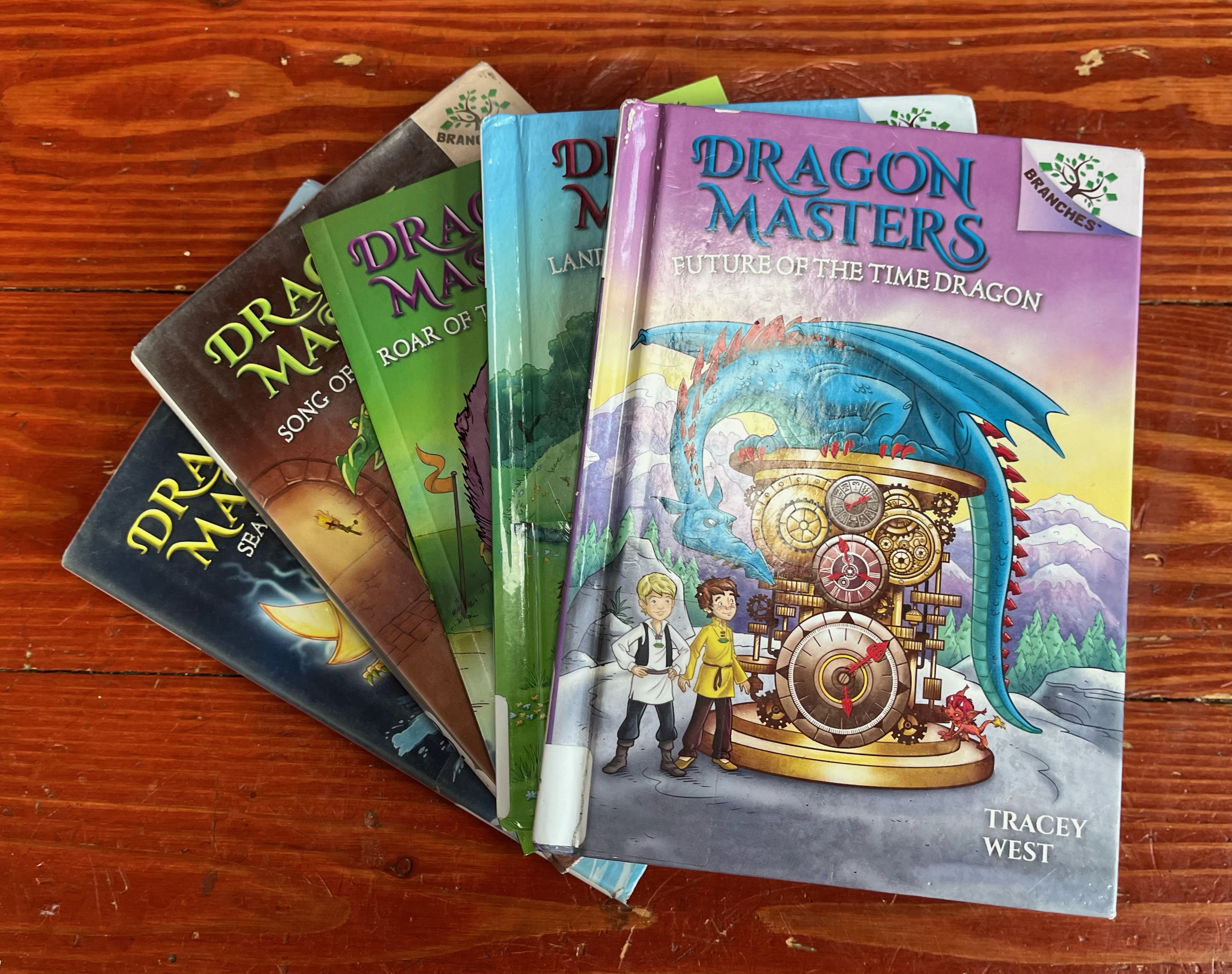Dragon Masters books by Tracey West in fanned stack with Future of the Time Dragon on top