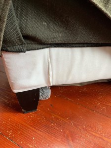 Sofa with GorillaPad underneath foot to prevent furniture from slipping or sliding or moving