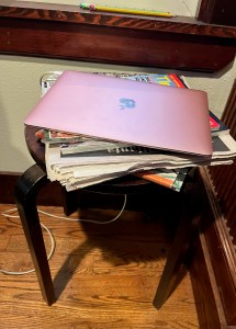 Stacking stool used a side table to hold laptop, magazines